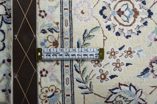 Backside of handmade New Nain rug showing knot structure and weave density