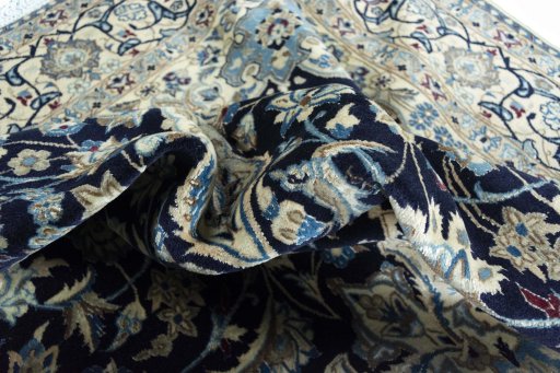 Backside of handmade 2000s Nain rug showing knot structure and weave density