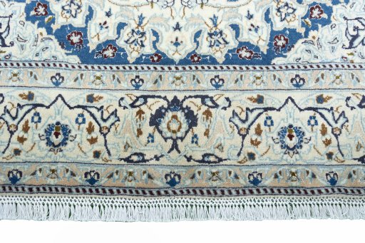 Corner detail of 2000s Nain rug showing border pattern and Wool pile