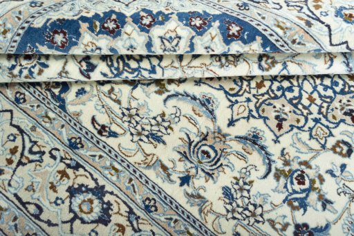 Surface texture of 2000s Nain rug with natural Wool and intricate pattern