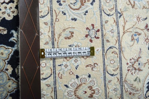 Backside of handmade New Nain rug showing knot structure and weave density