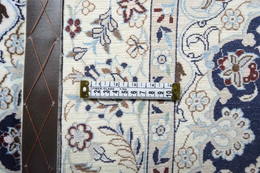 Backside of handmade New Nain rug showing knot structure and weave density