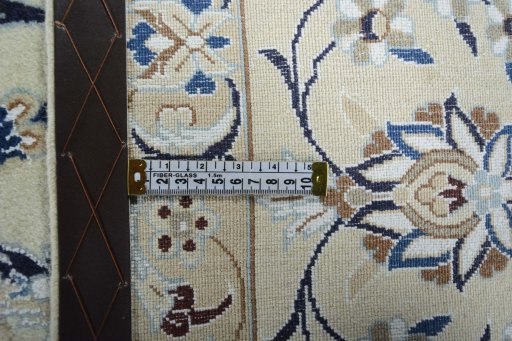 Backside of handmade New Nain rug showing knot structure and weave density