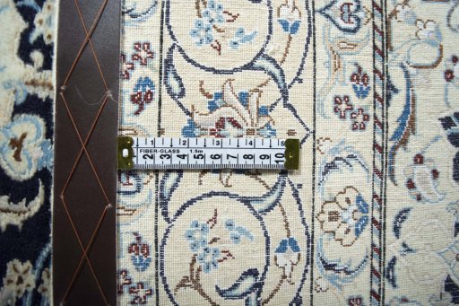 Backside of handmade New Nain rug showing knot structure and weave density