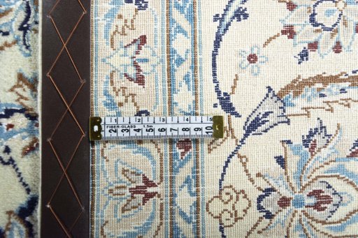 Backside of handmade New Nain rug showing knot structure and weave density