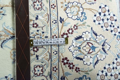 Backside of handmade New Nain rug showing knot structure and weave density
