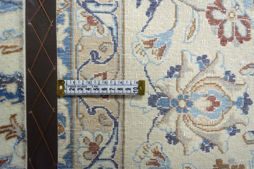 Backside of handmade New Nain rug showing knot structure and weave density