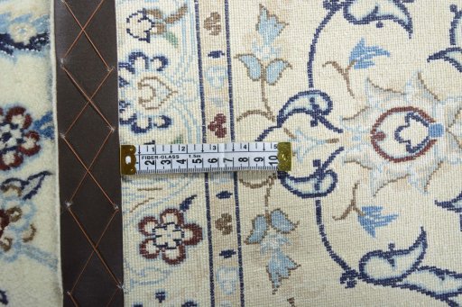 Backside of handmade New Nain rug showing knot structure and weave density