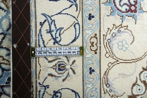 Backside of handmade New Nain rug showing knot structure and weave density