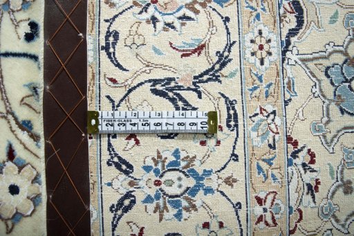 Backside of handmade New Nain rug showing knot structure and weave density