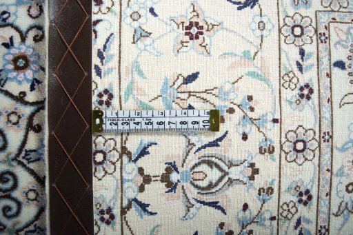 Backside of handmade New Nain rug showing knot structure and weave density