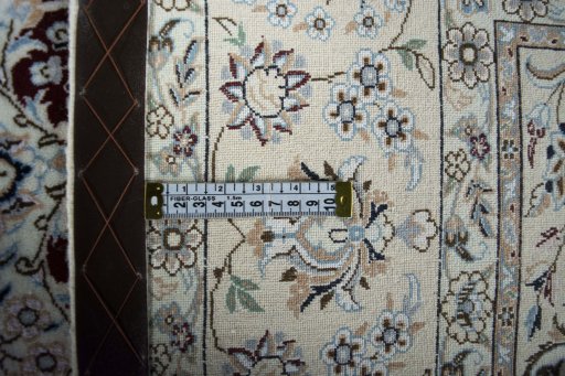 Backside of handmade New Nain rug showing knot structure and weave density