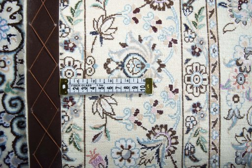 Backside of handmade New Nain rug showing knot structure and weave density