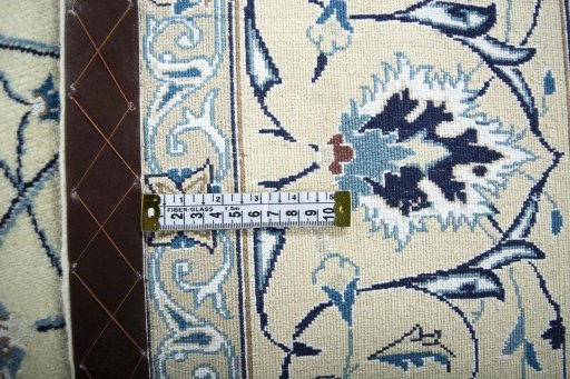 Backside of handmade New Nain rug showing knot structure and weave density
