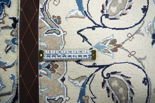 Backside of handmade New Nain rug showing knot structure and weave density