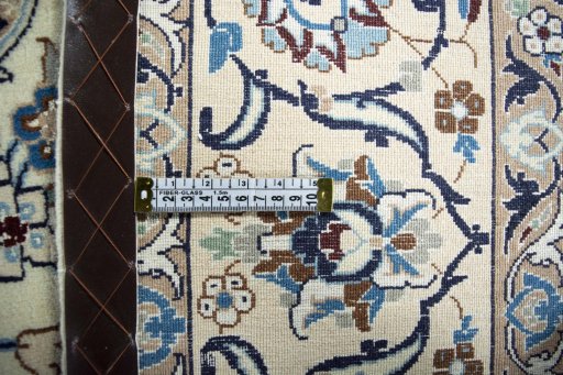 Backside of handmade New Nain rug showing knot structure and weave density