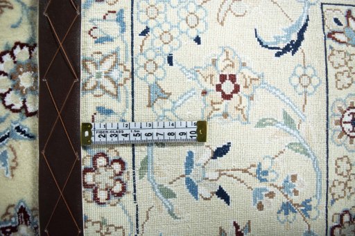 Backside of handmade New Nain rug showing knot structure and weave density