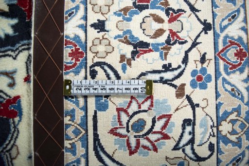 Backside of handmade New Nain rug showing knot structure and weave density