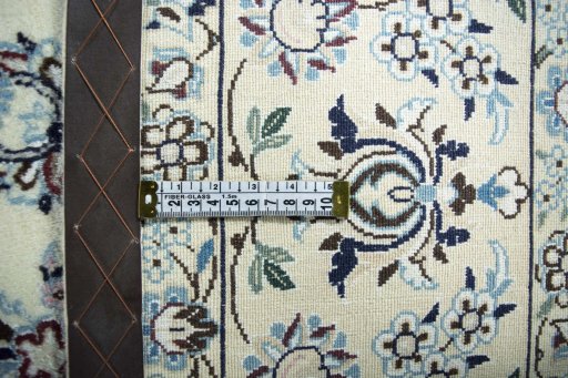 Backside of handmade New Nain rug showing knot structure and weave density