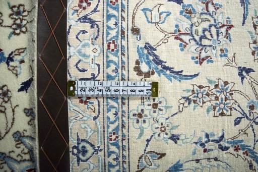Backside of handmade New Nain rug showing knot structure and weave density