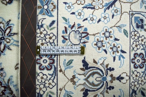 Backside of handmade New Nain rug showing knot structure and weave density
