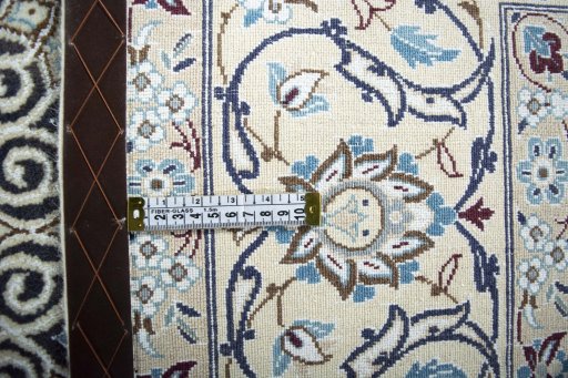 Backside of handmade New Nain rug showing knot structure and weave density