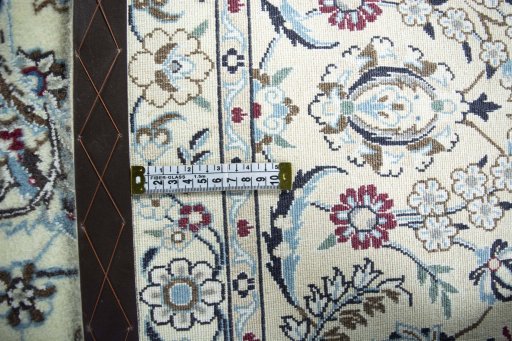 Backside of handmade New Nain rug showing knot structure and weave density