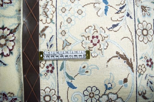 Backside of handmade New Nain rug showing knot structure and weave density