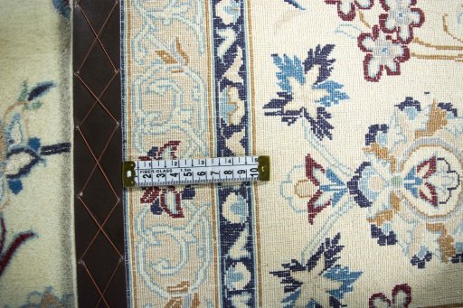 Backside of handmade 2000s Nain rug showing knot structure and weave density