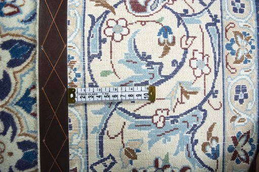 Backside of handmade 2000s Nain rug showing knot structure and weave density