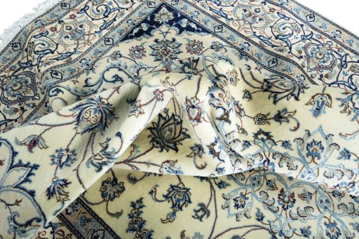Backside of handmade New Nain rug showing knot structure and weave density