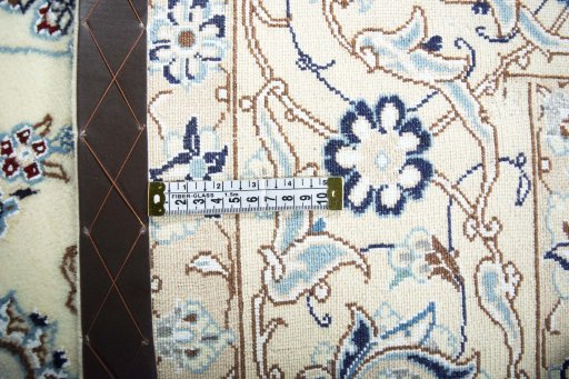 Backside of handmade New Nain rug showing knot structure and weave density
