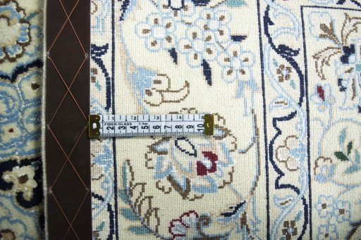 Backside of handmade New Nain rug showing knot structure and weave density