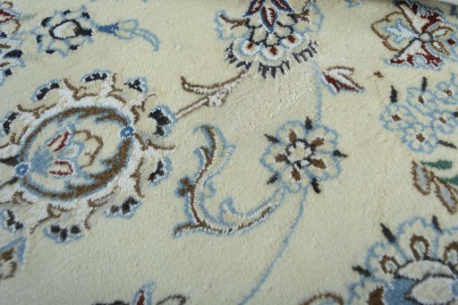 Backside of handmade New Nain rug showing knot structure and weave density
