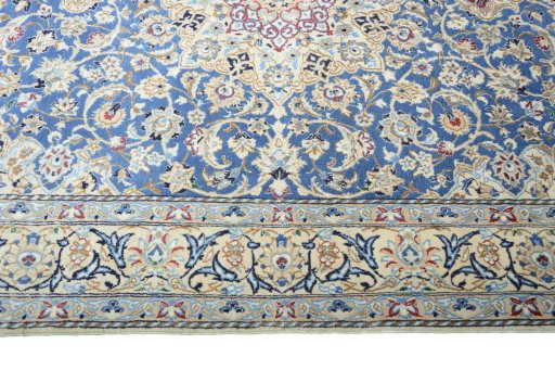 Corner detail of 2000s Nain rug showing border pattern and Wool pile