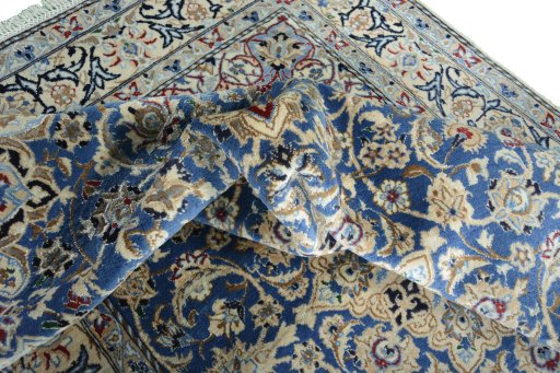Surface texture of 2000s Nain rug with natural Wool and intricate pattern