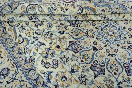 Surface texture of 2000s Nain rug with natural Wool and intricate pattern