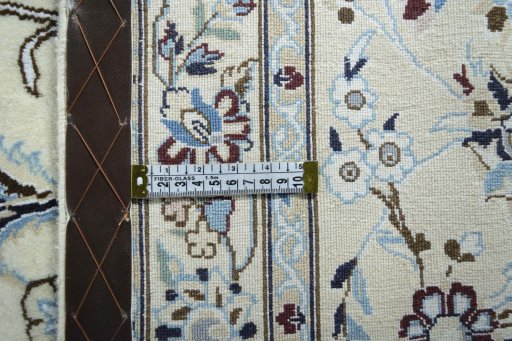 Backside of handmade New Nain rug showing knot structure and weave density
