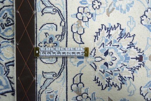 Backside of handmade New Nain rug showing knot structure and weave density
