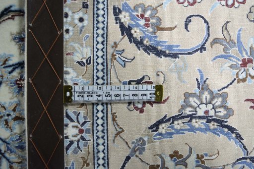 Backside of handmade New Nain rug showing knot structure and weave density