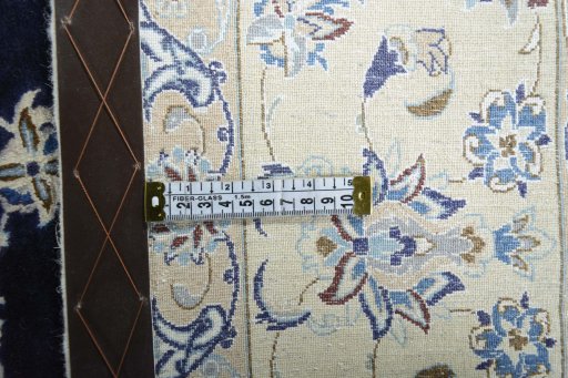 Backside of handmade 2000s Nain rug showing knot structure and weave density