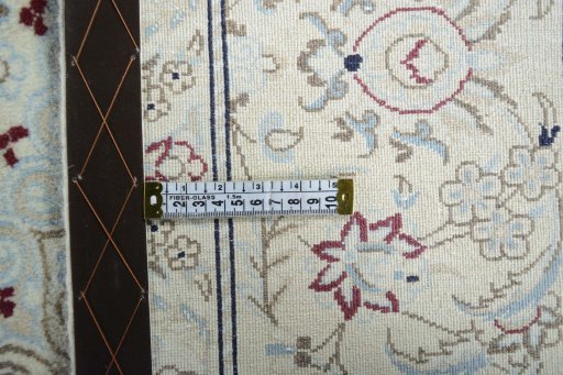 Backside of handmade New Nain rug showing knot structure and weave density