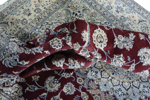 Surface texture of 2000s Nain rug with natural Wool and intricate pattern