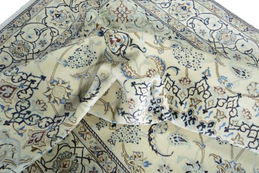 Surface texture of 2000s Nain rug with natural Wool and intricate pattern