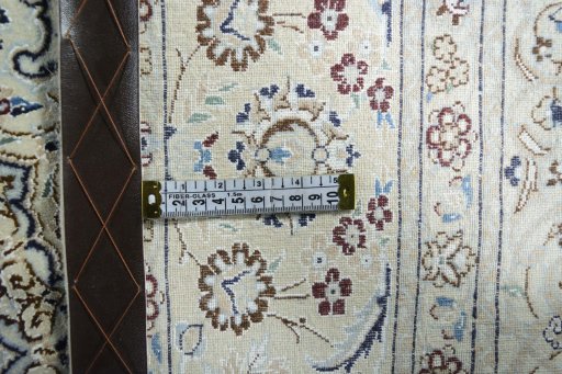 Backside of handmade New Nain rug showing knot structure and weave density
