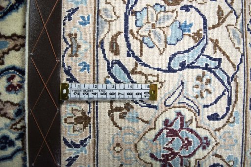 Backside of handmade New Nain rug showing knot structure and weave density