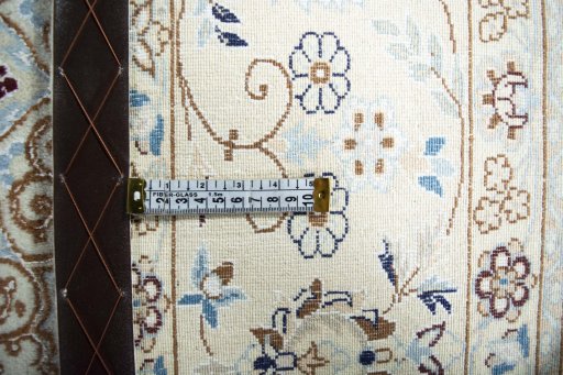 Backside of handmade New Nain rug showing knot structure and weave density