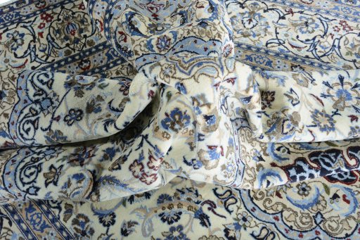 Surface texture of 2000s Nain rug with natural Wool and intricate pattern
