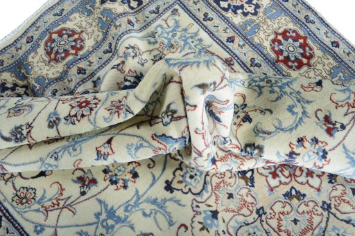 Surface texture of 2000s Nain rug with natural Wool and intricate pattern