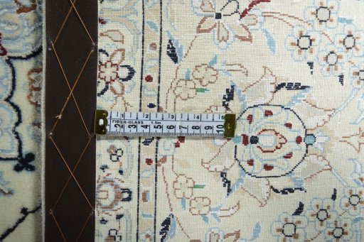 Backside of handmade New Nain rug showing knot structure and weave density